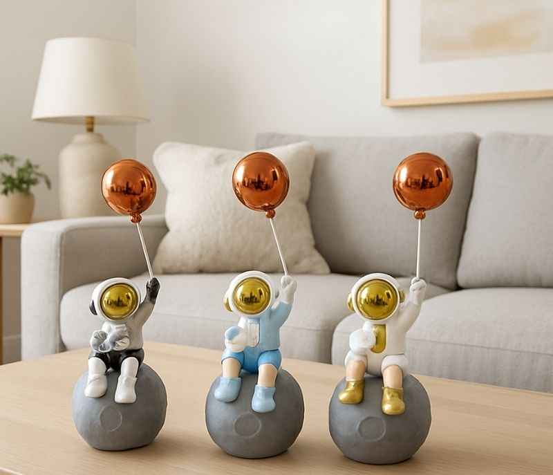 Image 1 for G-RA-02 A/B/C/D set of decorative astronaut figurines holding metallic balloons while sitting on a moon
